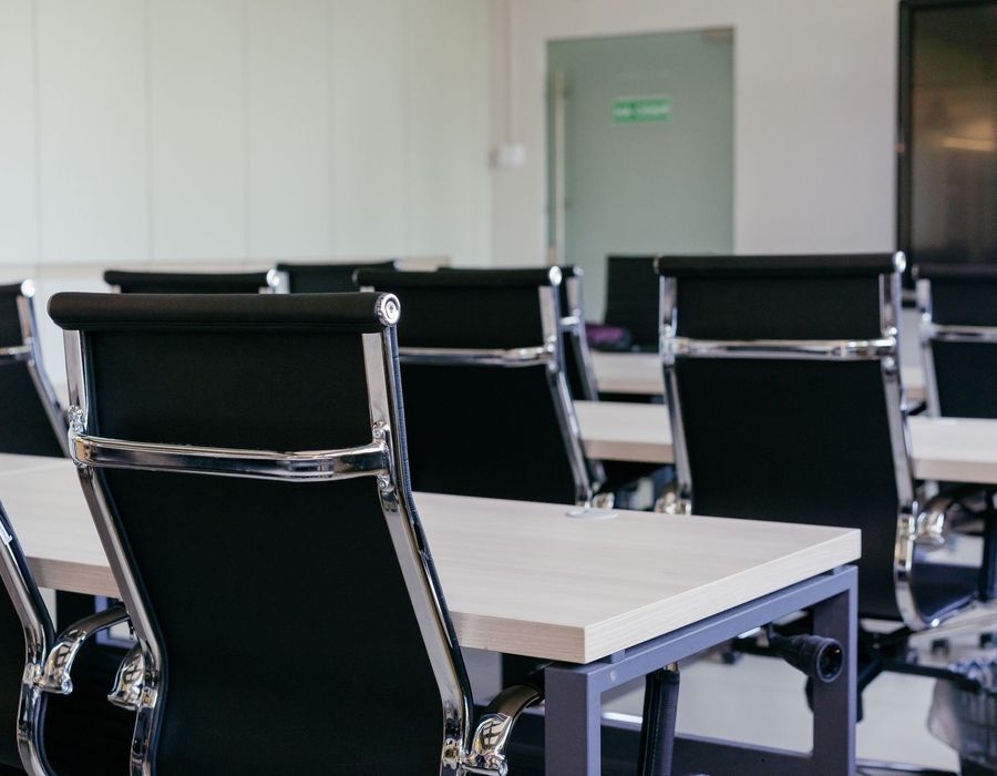 A pristine corporate boardroom with a long table ready for the working day