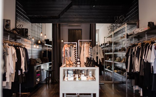 A bright, tidy clothing shop interior with merchandise on display