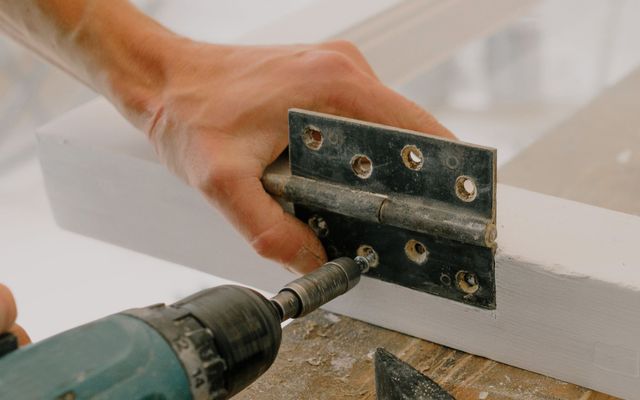 A workman fitting a window during a renovation project
